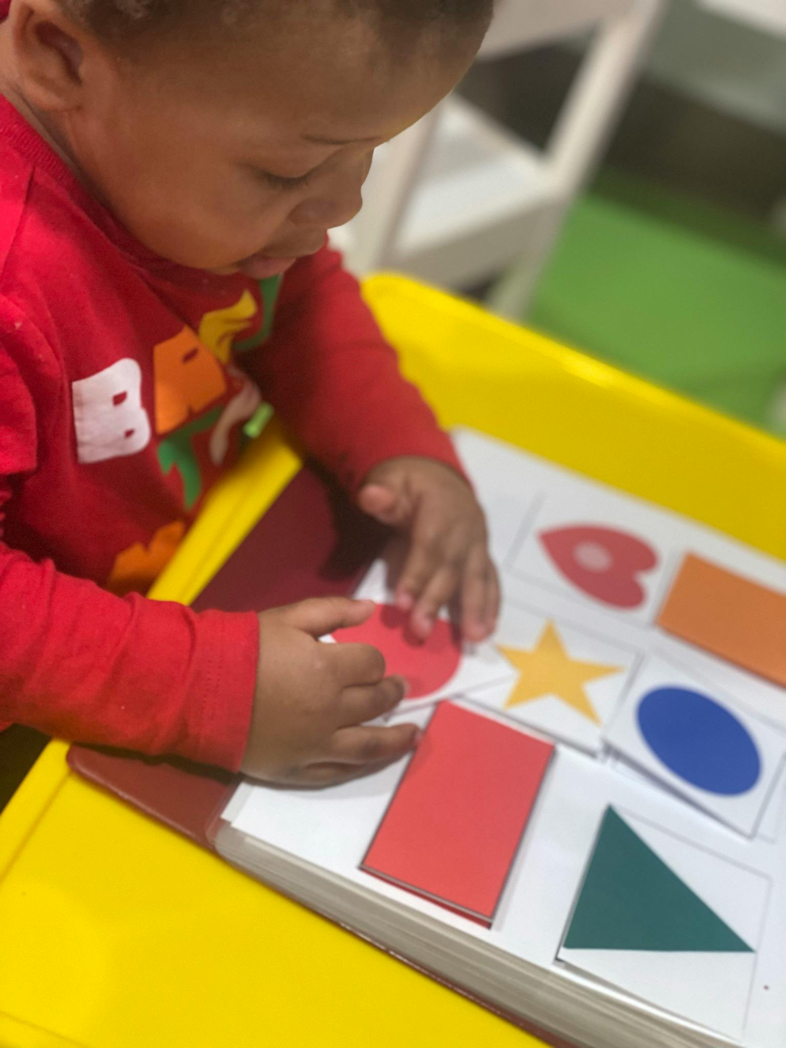 Child playing with shape sorter toy
