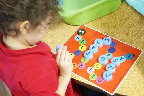 Child playing with alphabet letter game