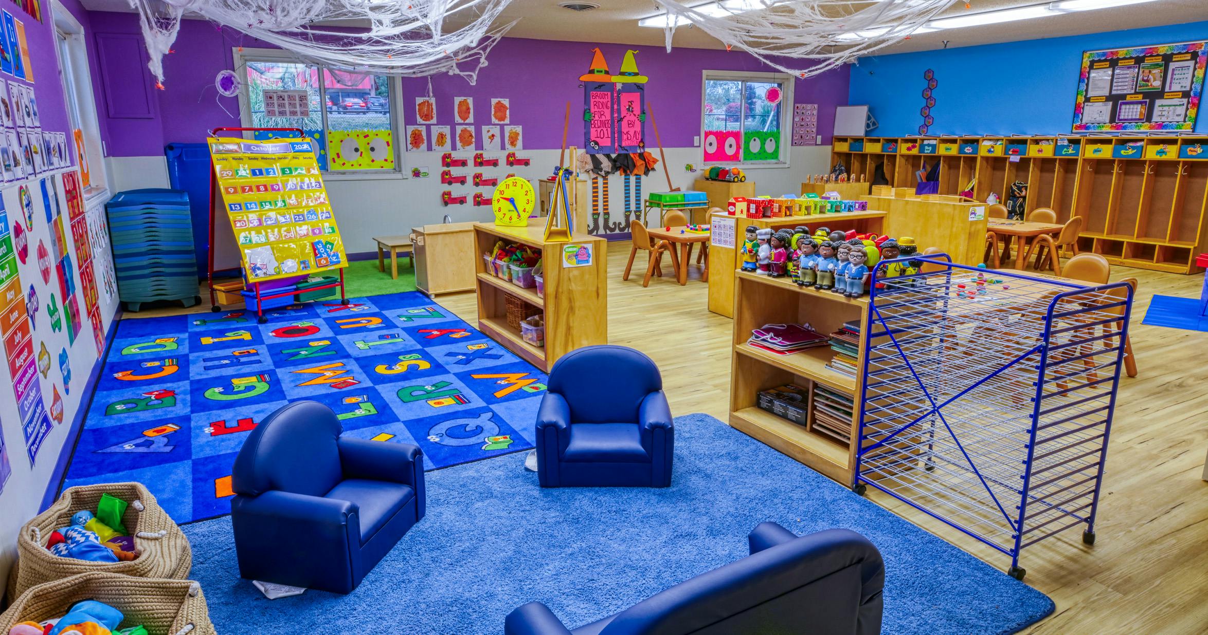 Classroom decorated for Halloween with a calendar and play area