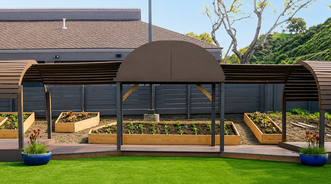 Wooden raised garden beds beneath an arched pergola structure