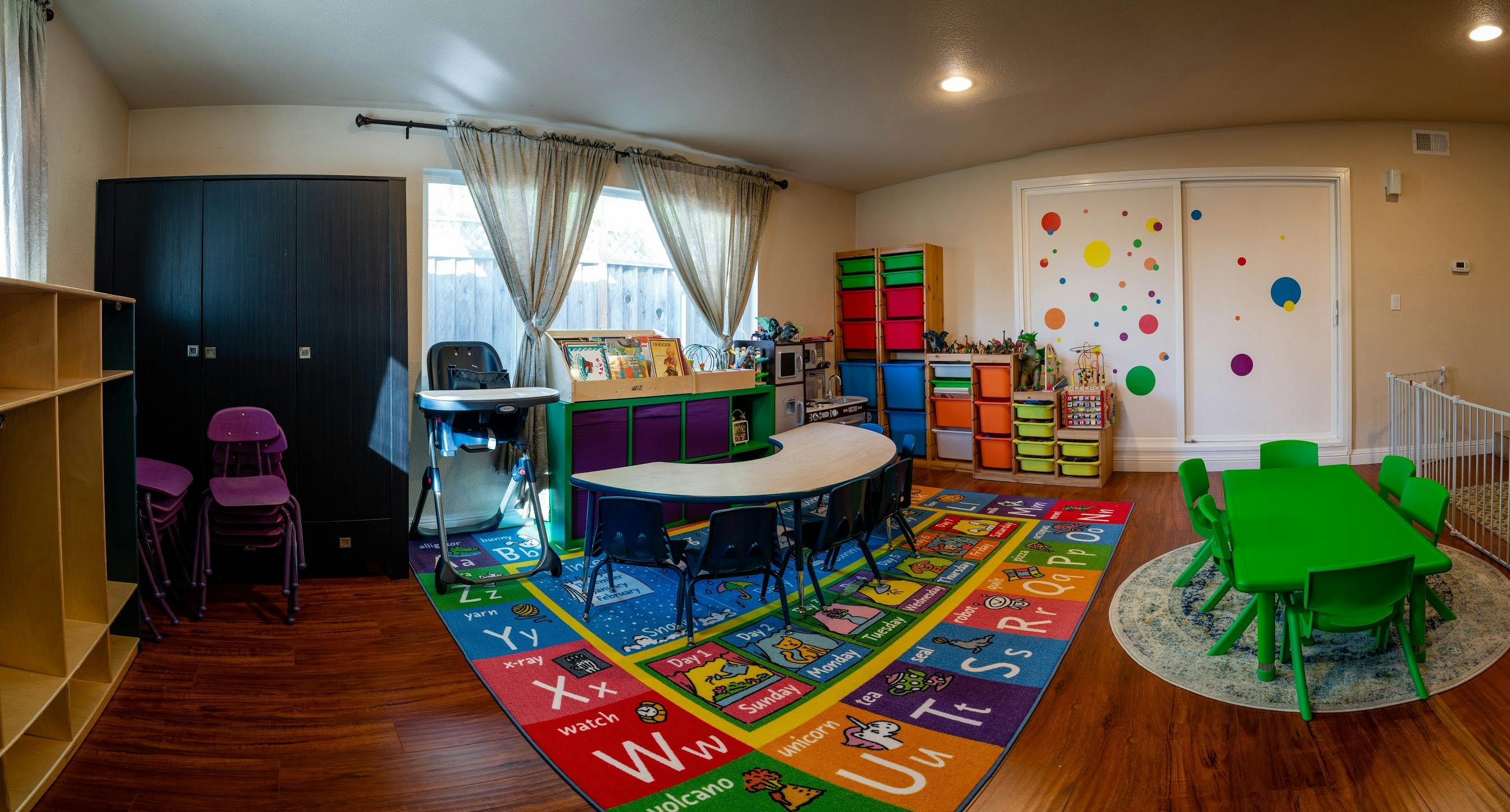 Classroom with colorful rug, tables, and chairs