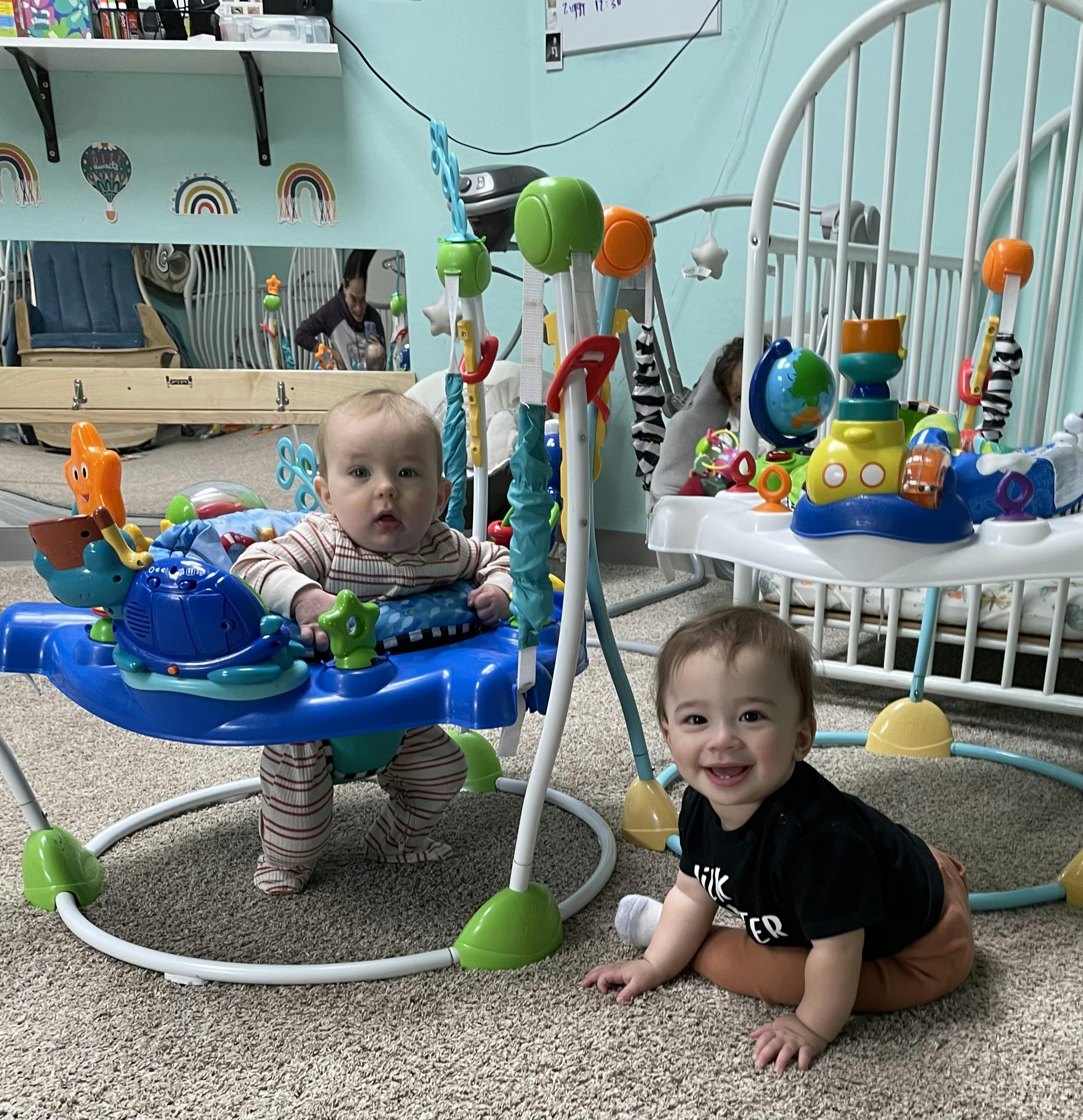 Two children playing in a room with activity toys