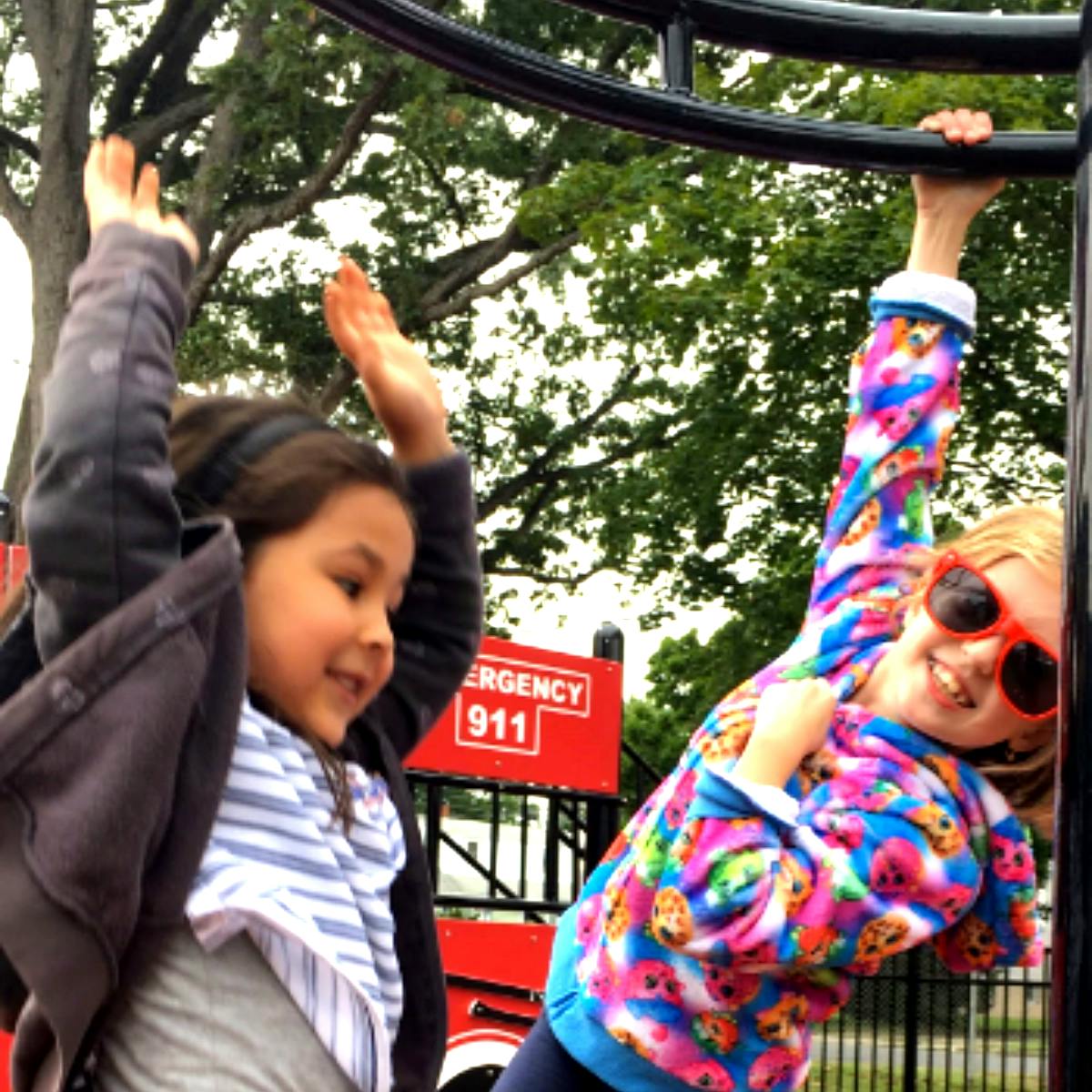 Two children playing on a jungle gym