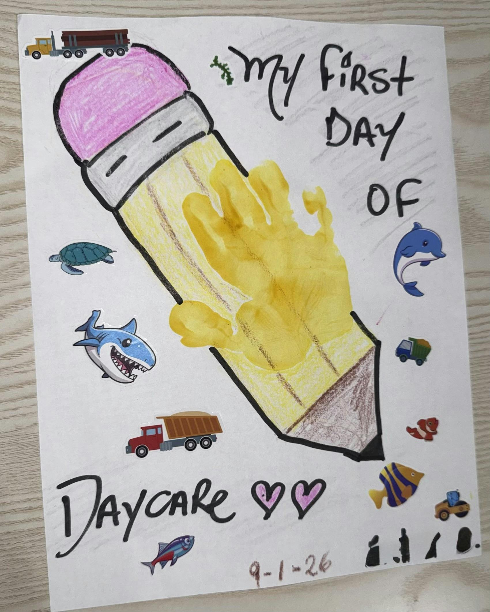 Child handprint craft shaped like a pencil with My First Day of Daycare text