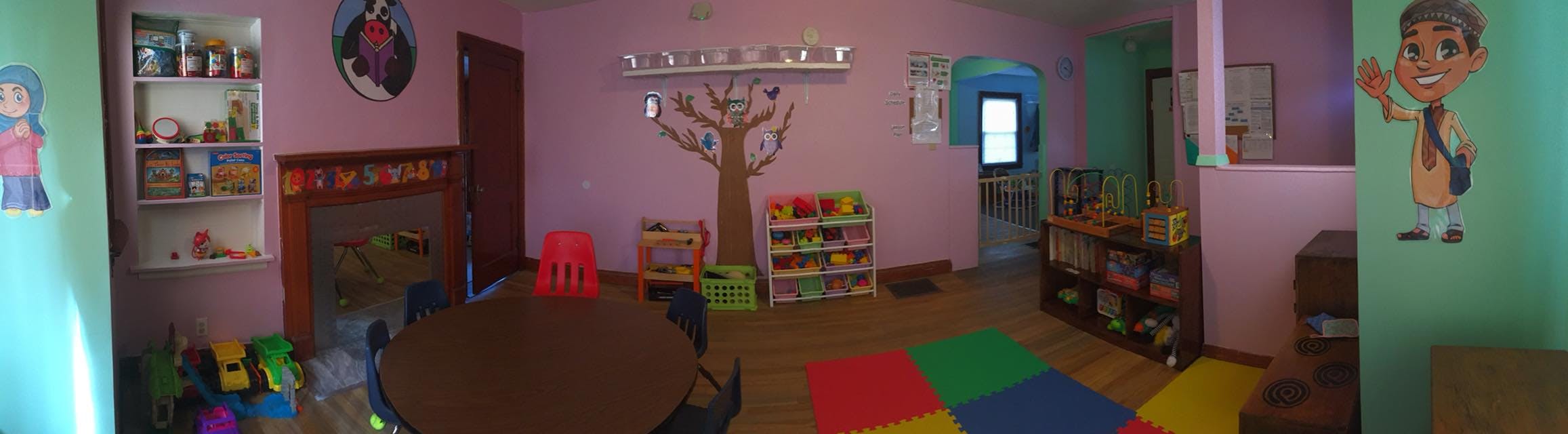 Playroom with colorful floor mats and shelves of toys