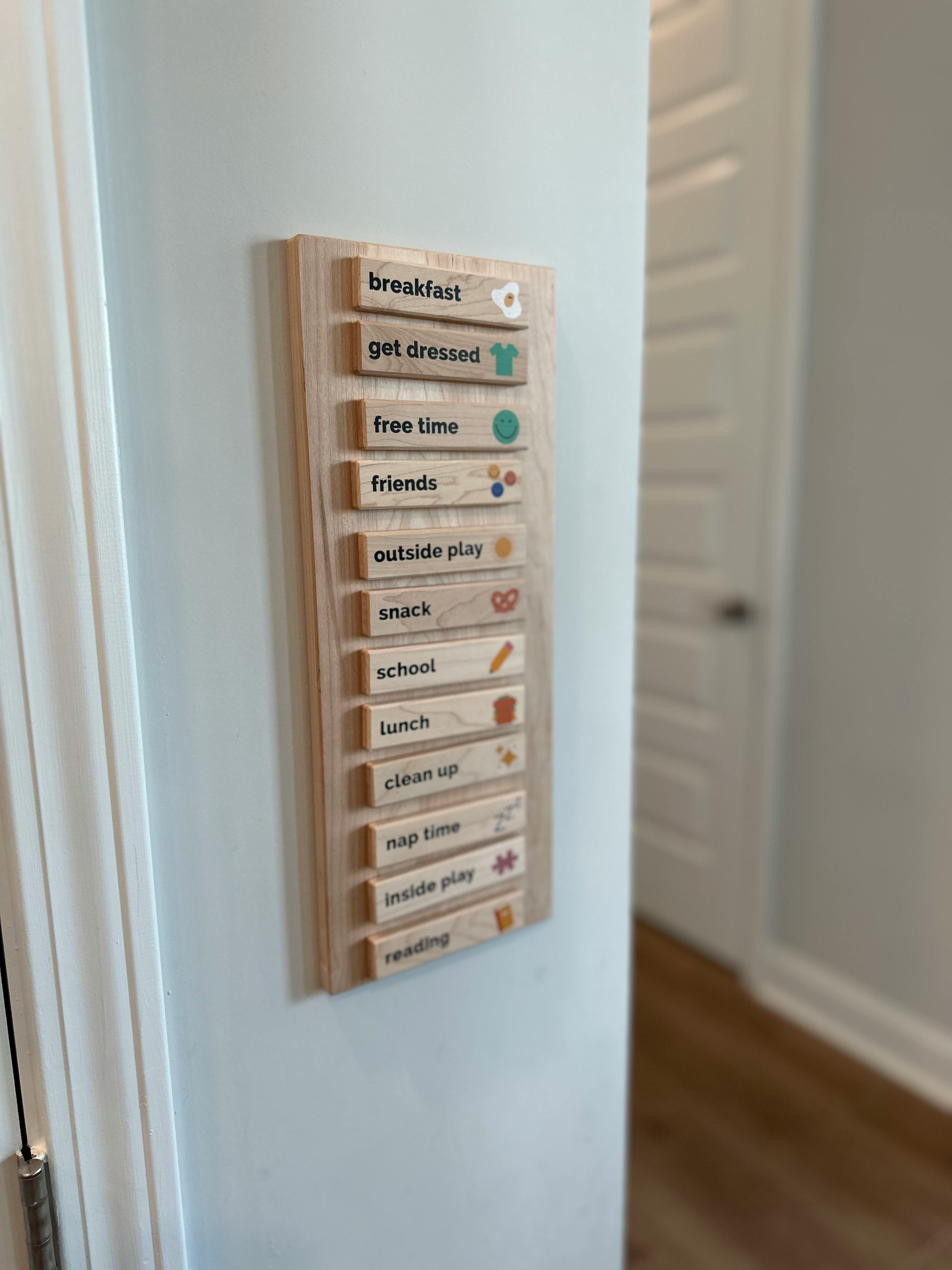 Wooden chore chart with daily tasks like breakfast, get dressed, free time, and school