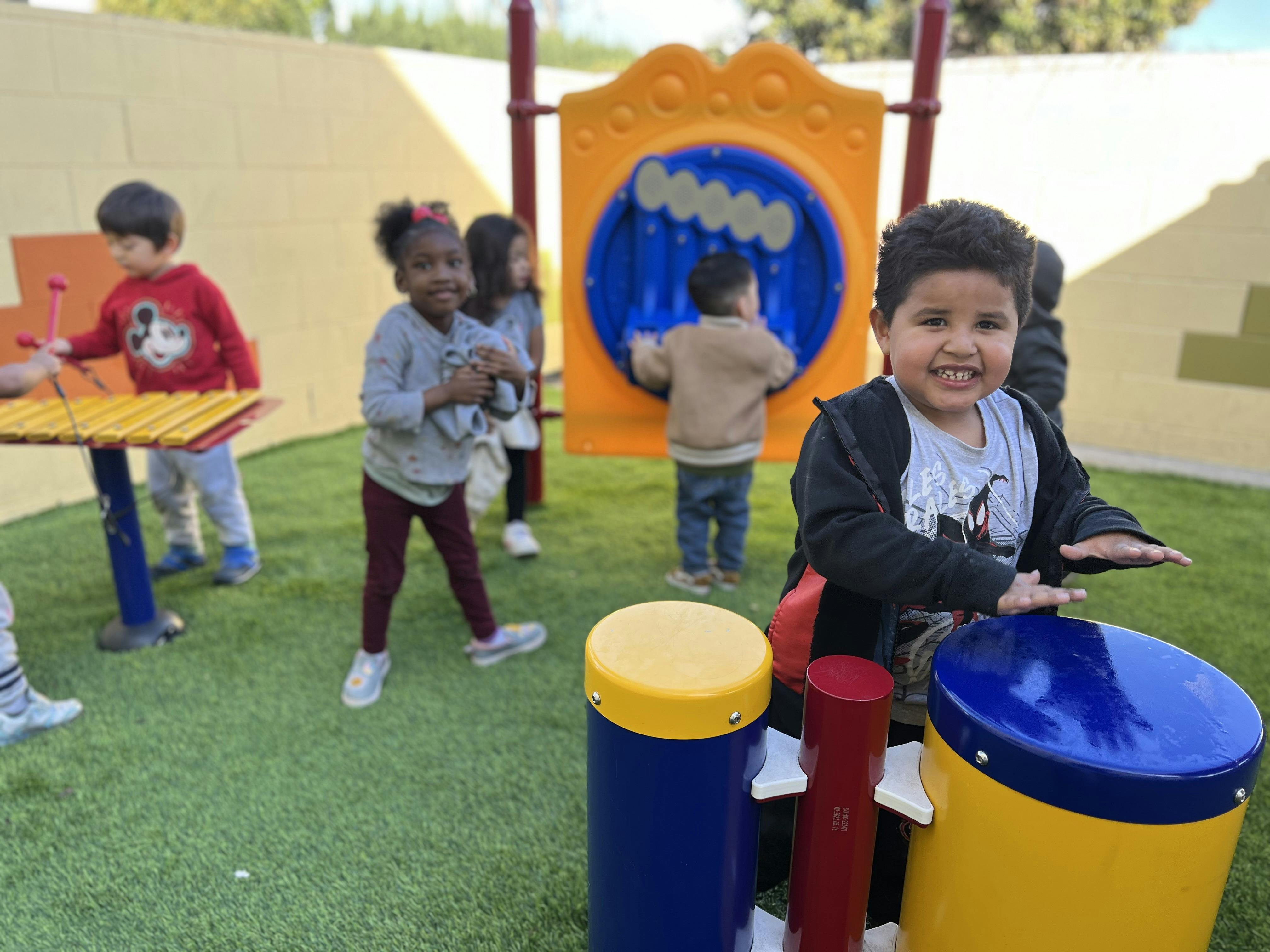 Children playing with musical instruments on a playground