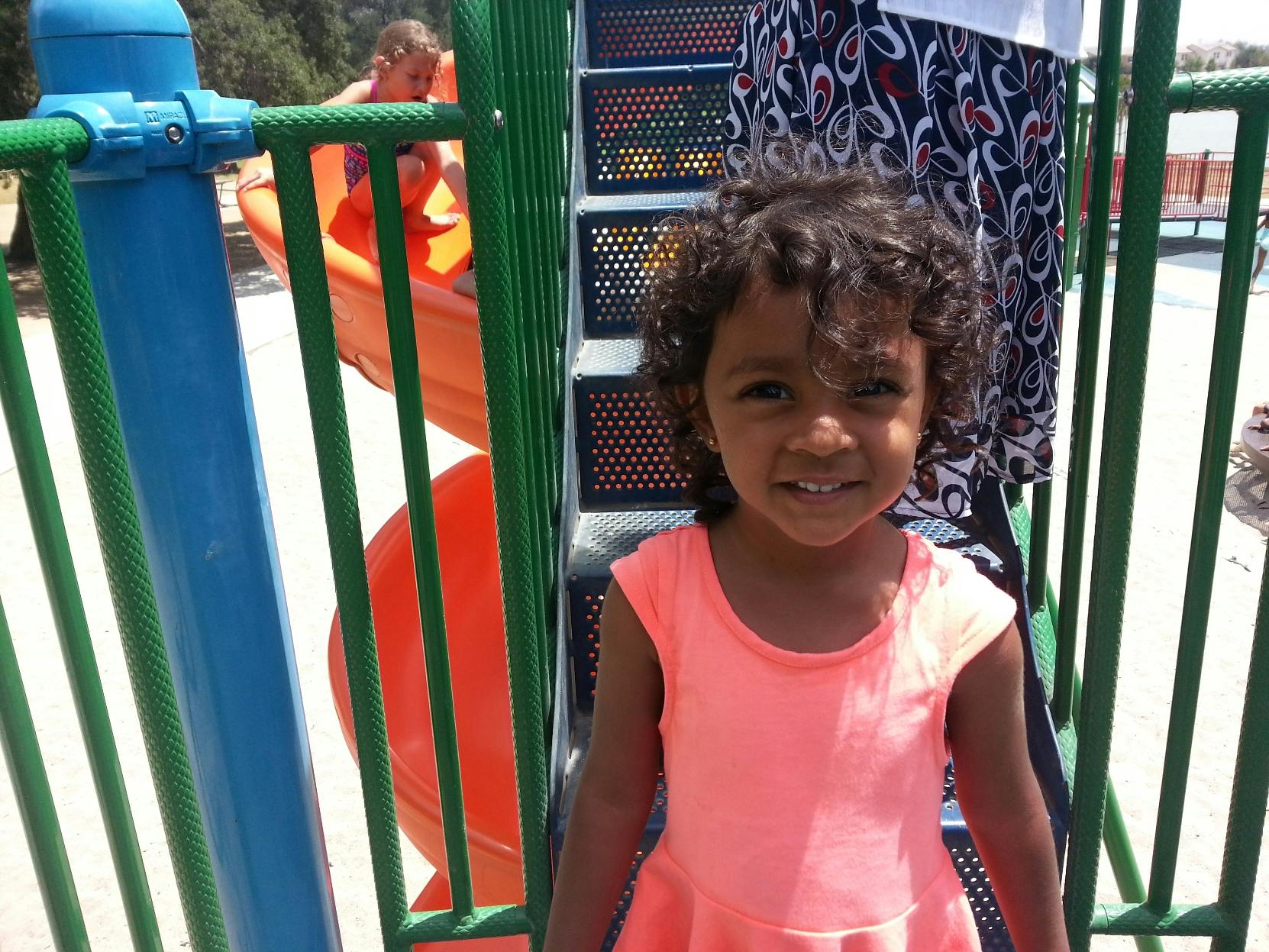 Child standing on playground equipment