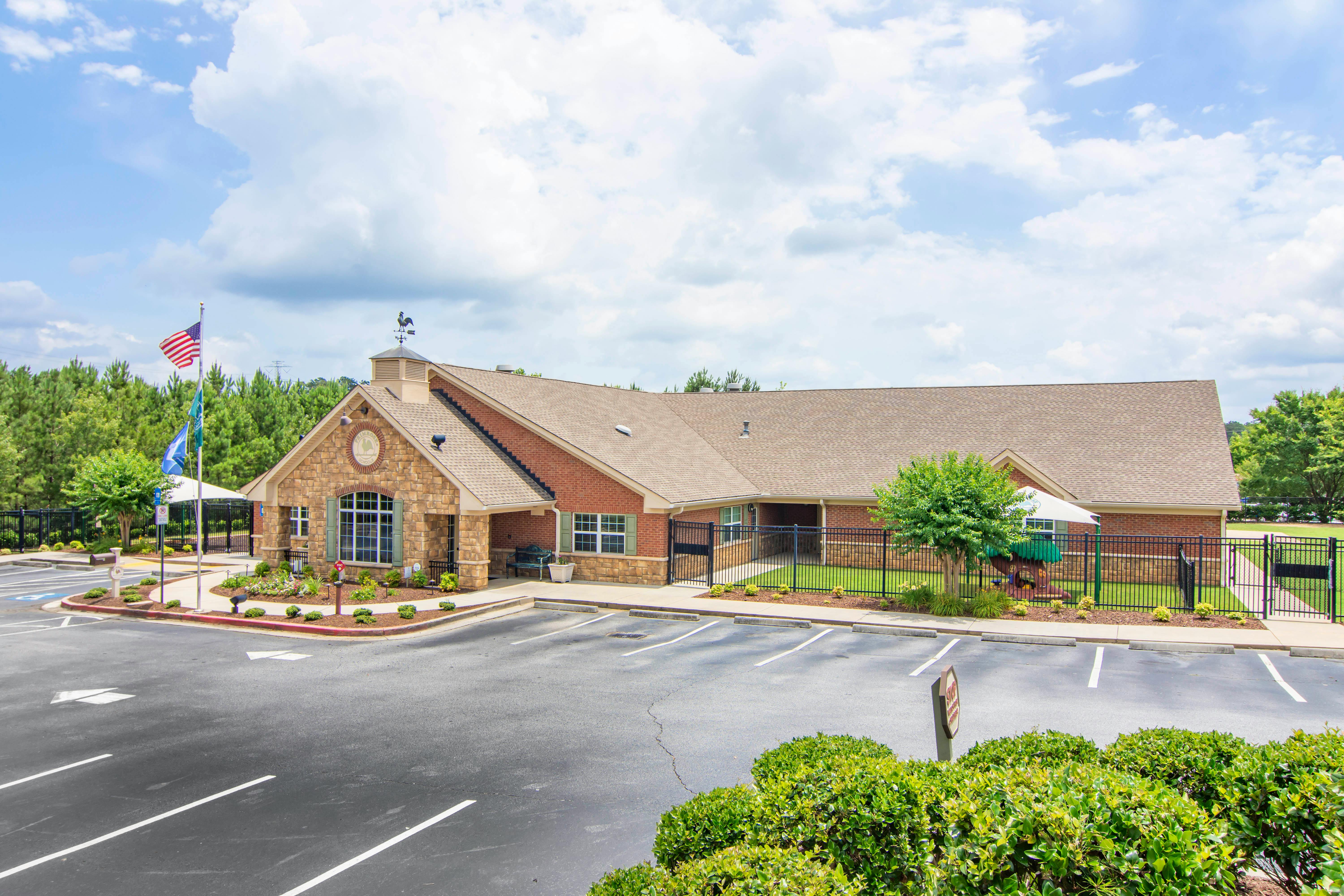 Brick building with a parking lot and flagpole with American flag