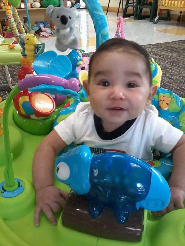 Child in a baby activity center