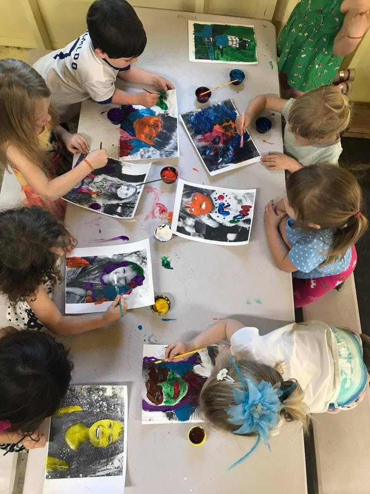 Children painting at a table