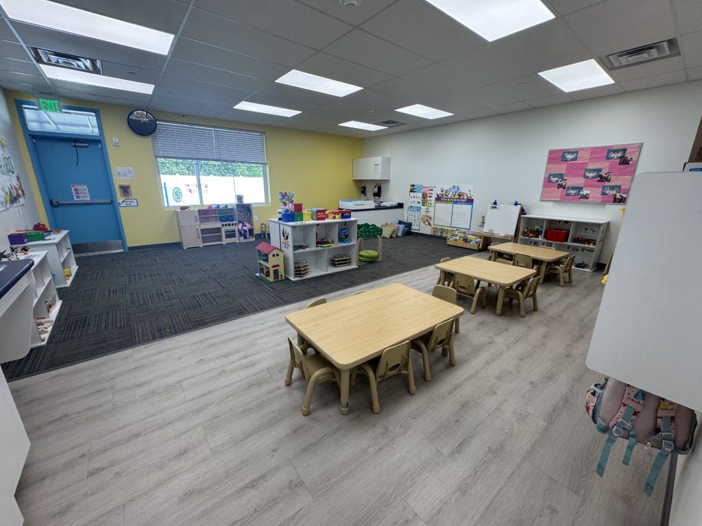 Empty classroom with small tables and chairs