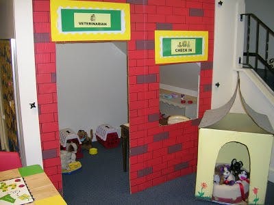 Play vet clinic with signs for "Veterinarian" and "Check In"