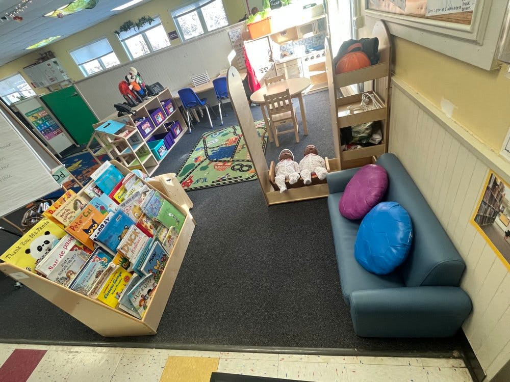 Classroom with children's books, small furniture, and play area