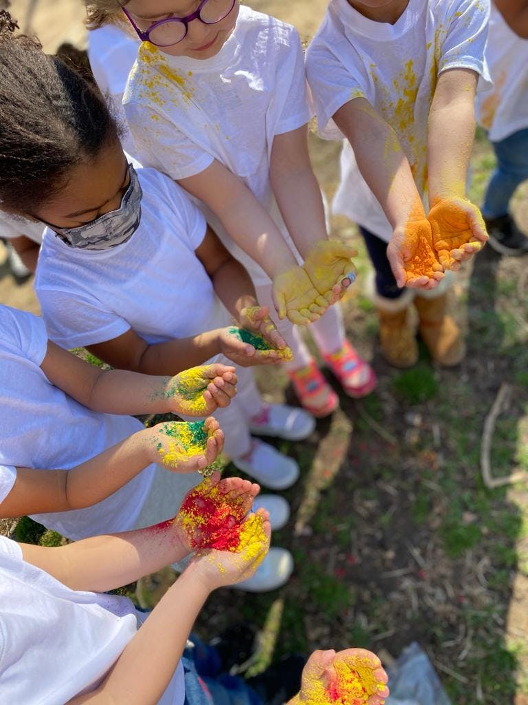 Children holding colorful powder in their hands