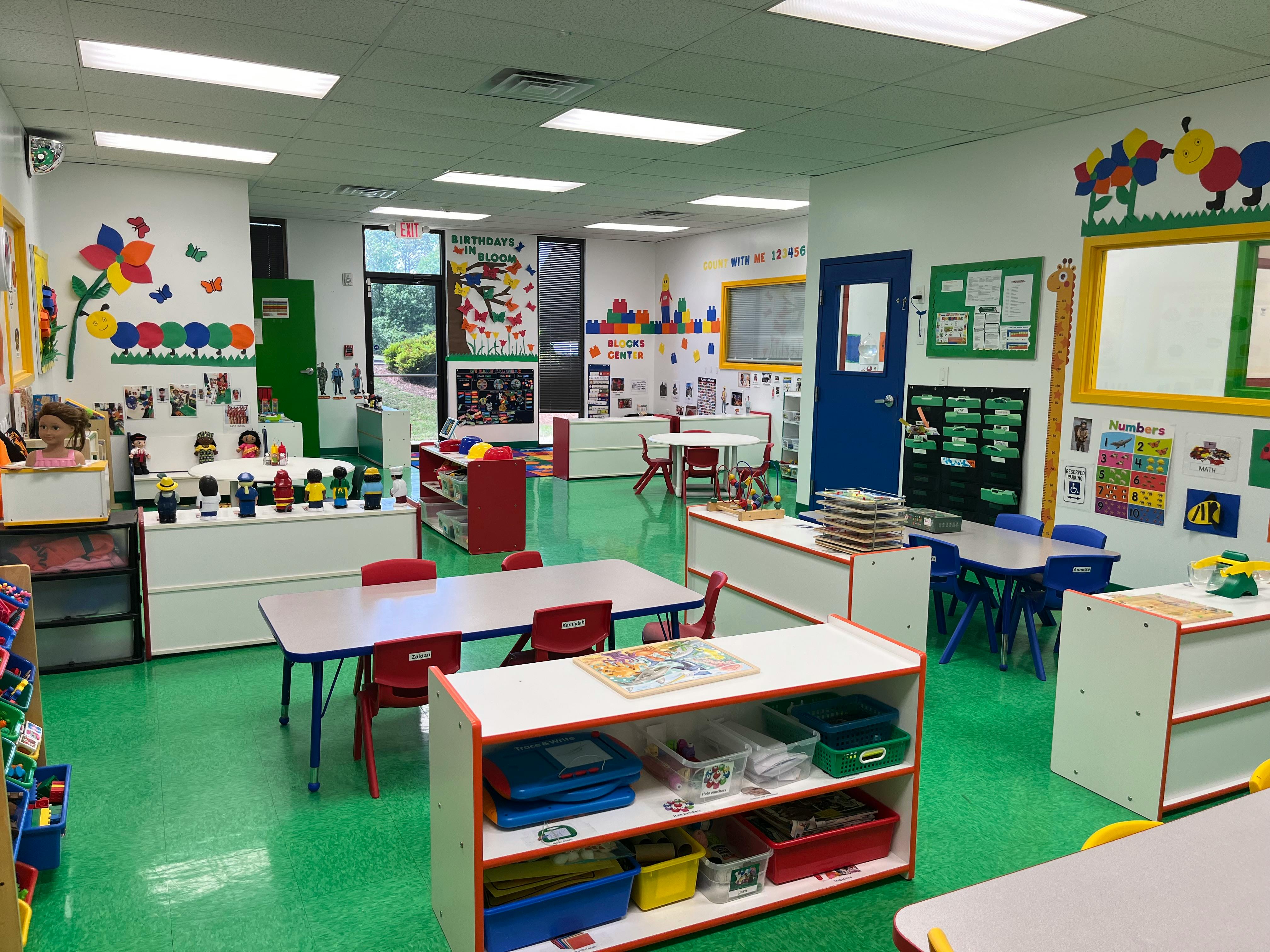 Empty classroom with small tables and chairs