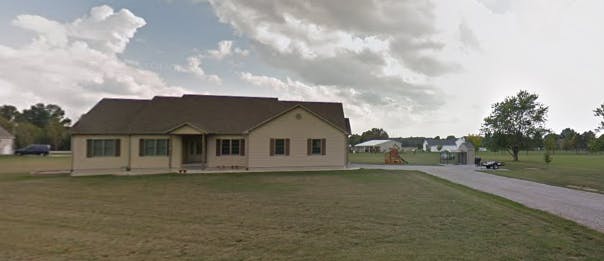 Single-story building with a brown roof and a driveway