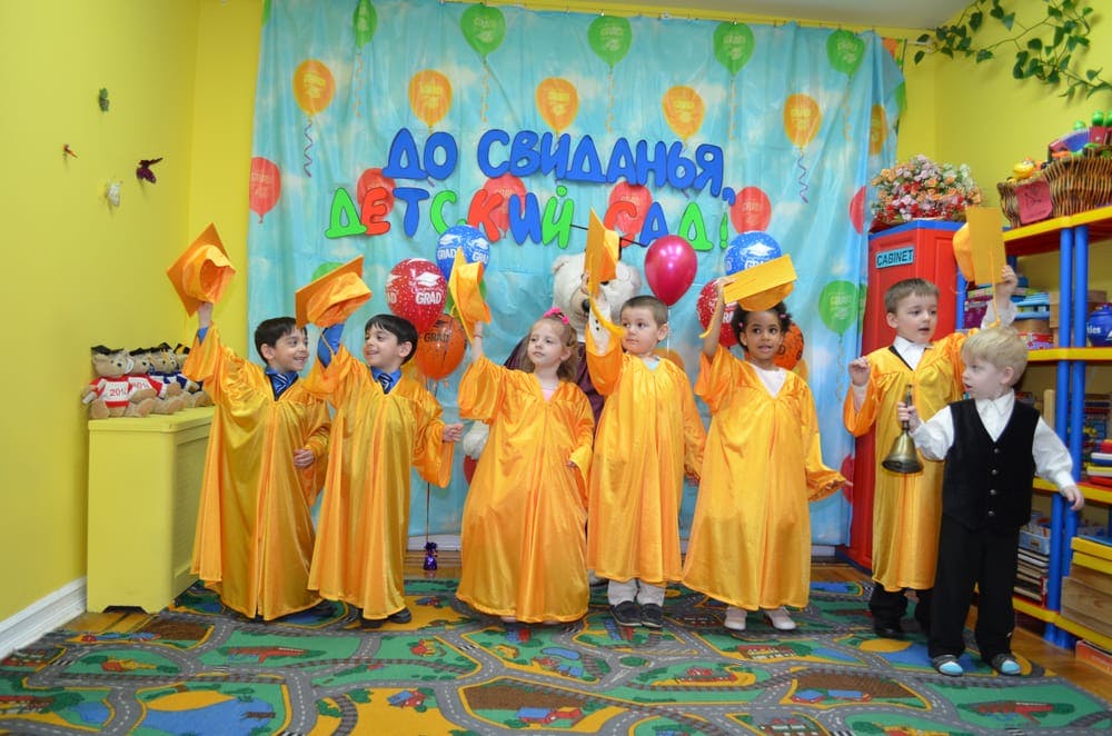 Children in yellow graduation gowns and caps