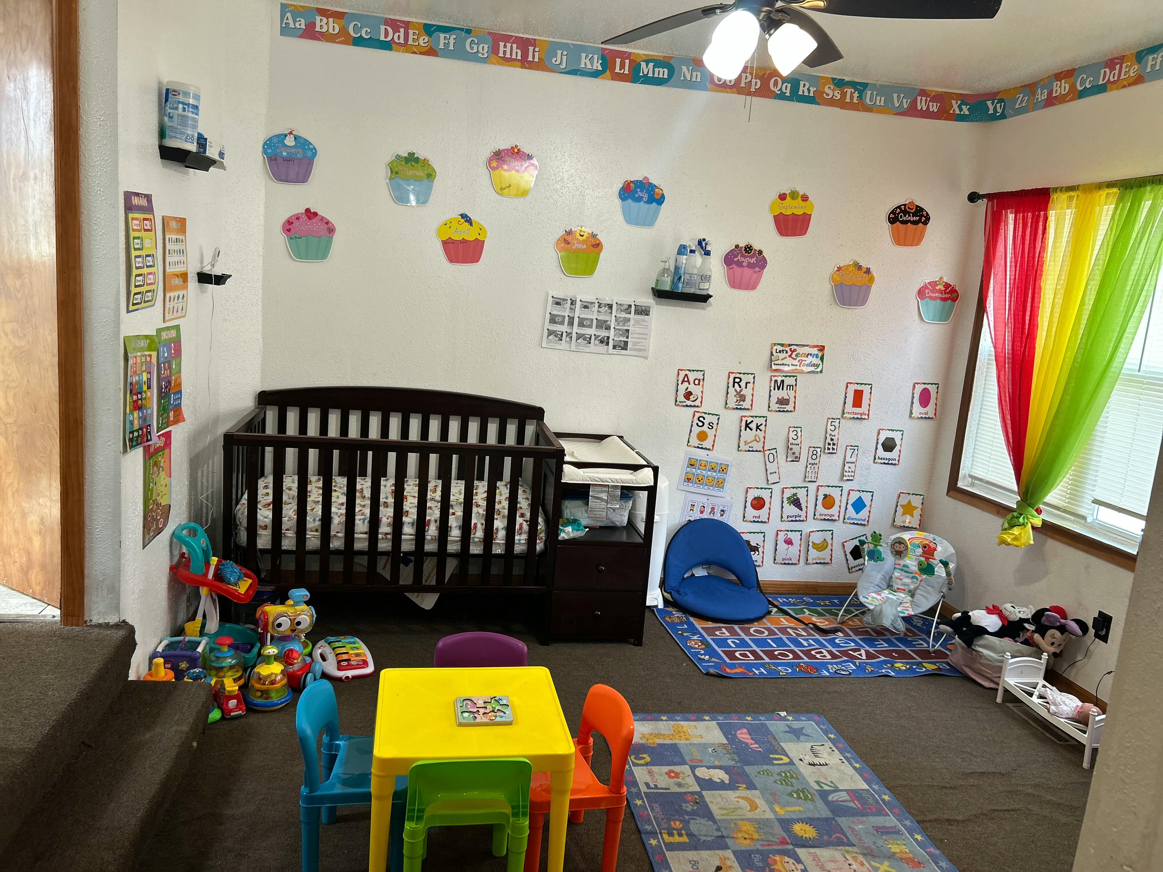 Nursery room with a crib, changing table, and colorful decorations