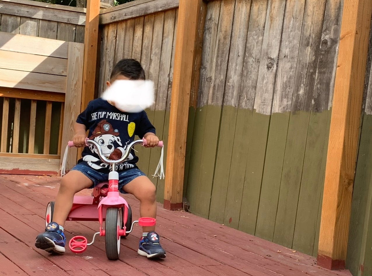 Child on a pink tricycle