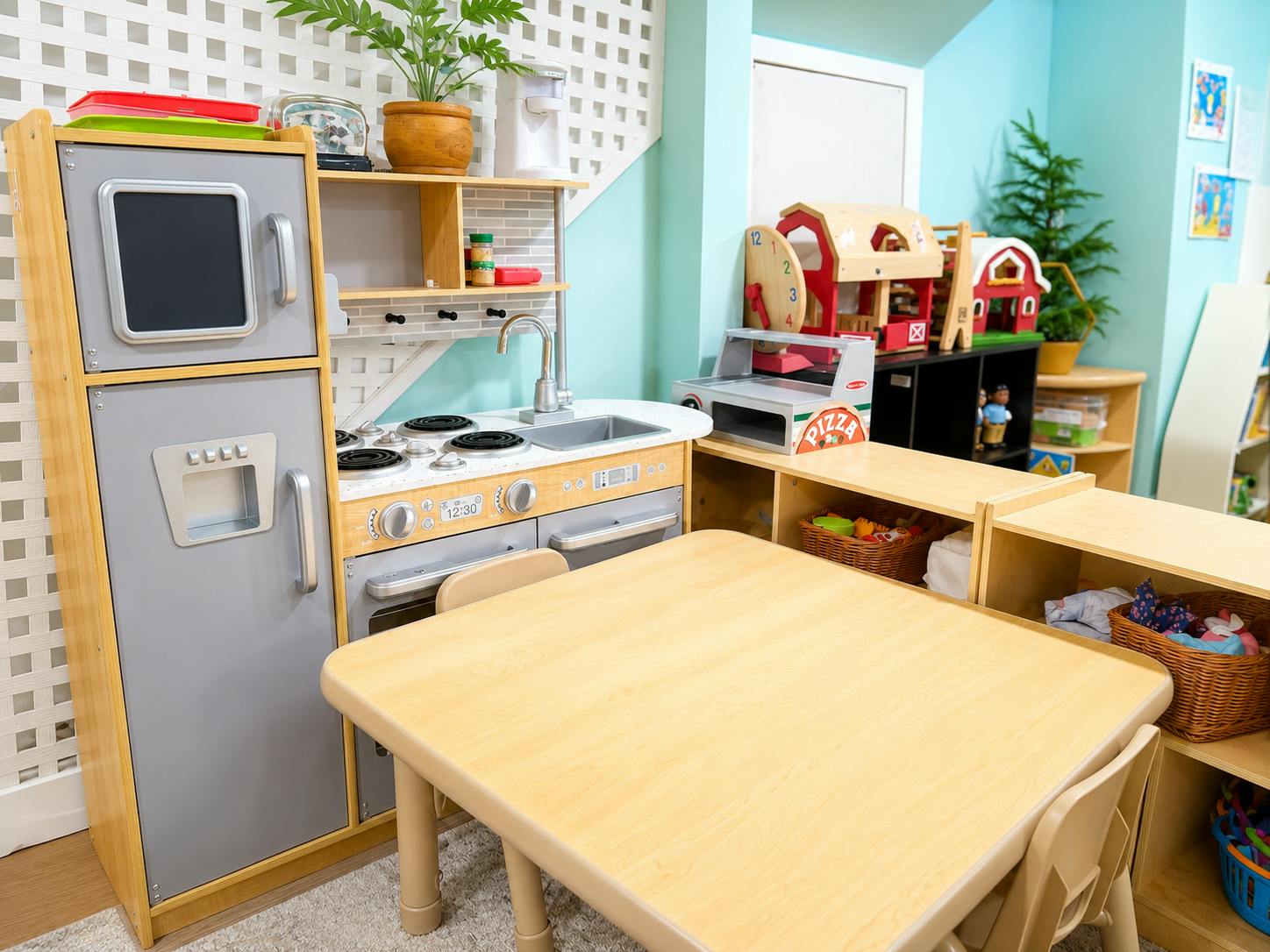 Wooden toy kitchen set and a play table in a classroom