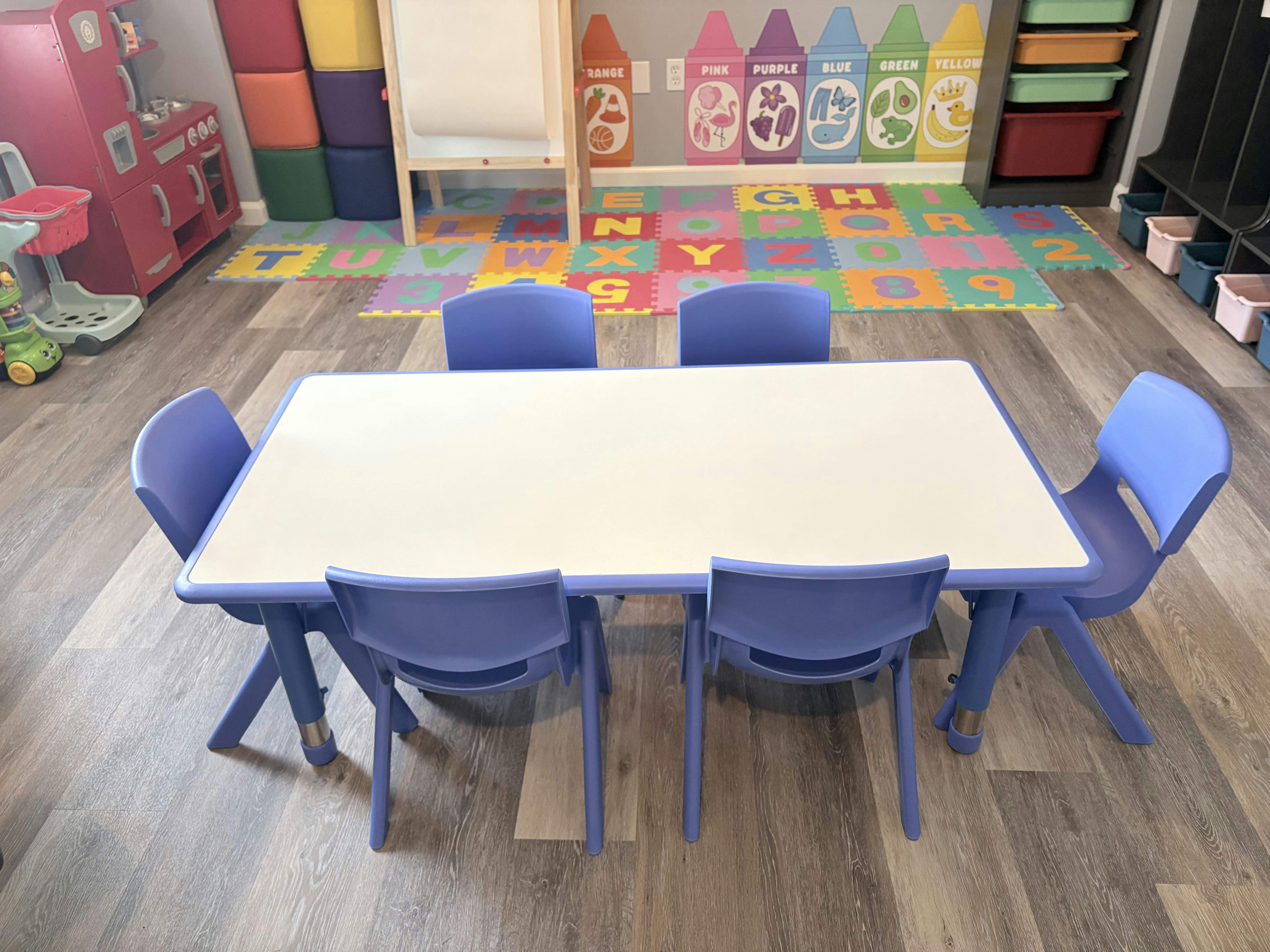 Small table with purple chairs in a playroom