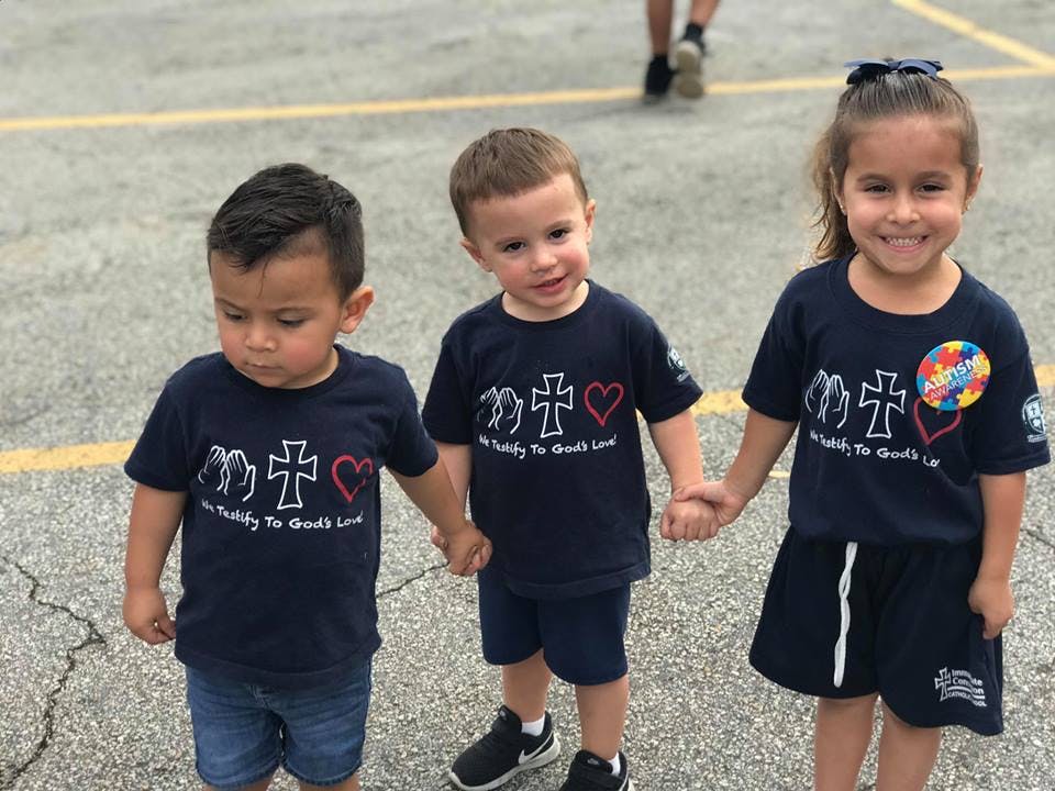 Three children holding hands