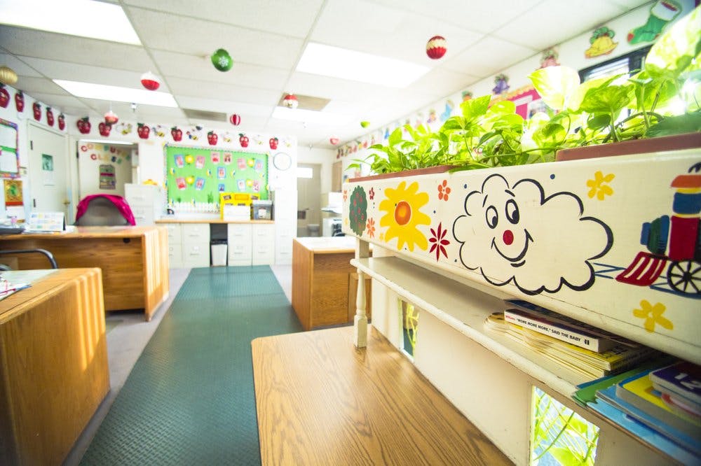 Classroom with a long planter box decorated with a cloud, sun, and train