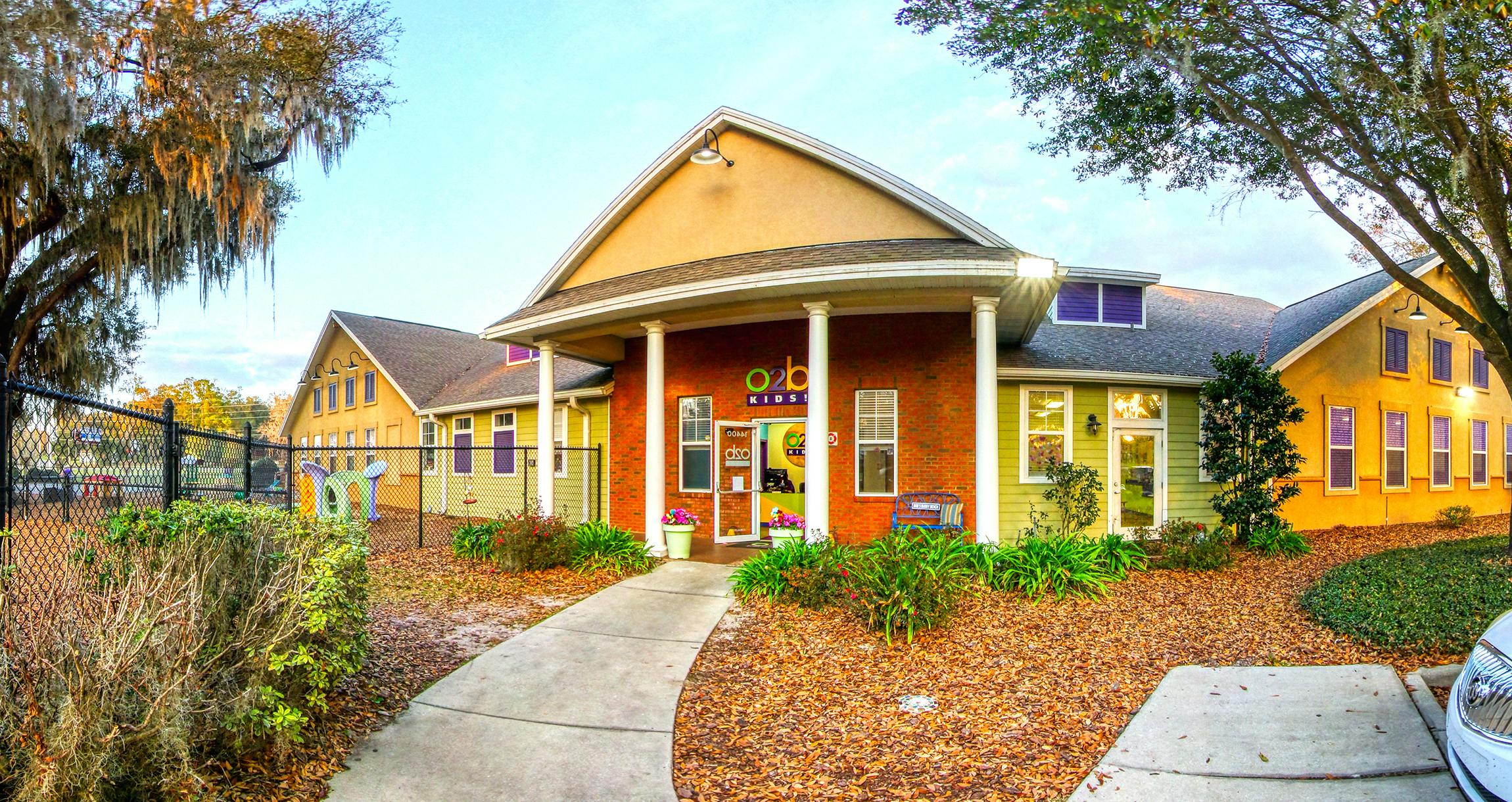 Colorful O2B Kids building with a sidewalk leading to the entrance
