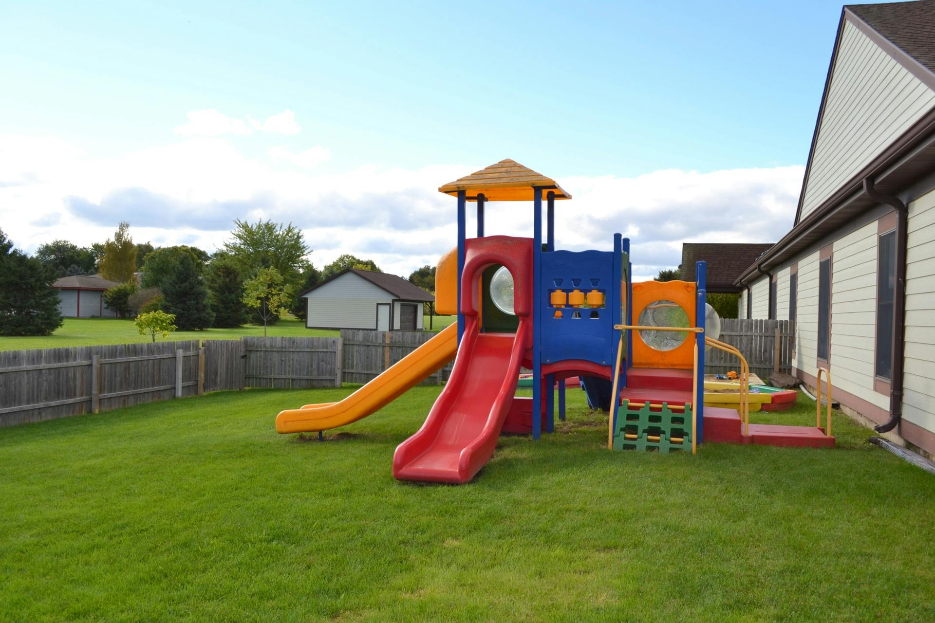 Playground structure with slides and climbing areas on grass