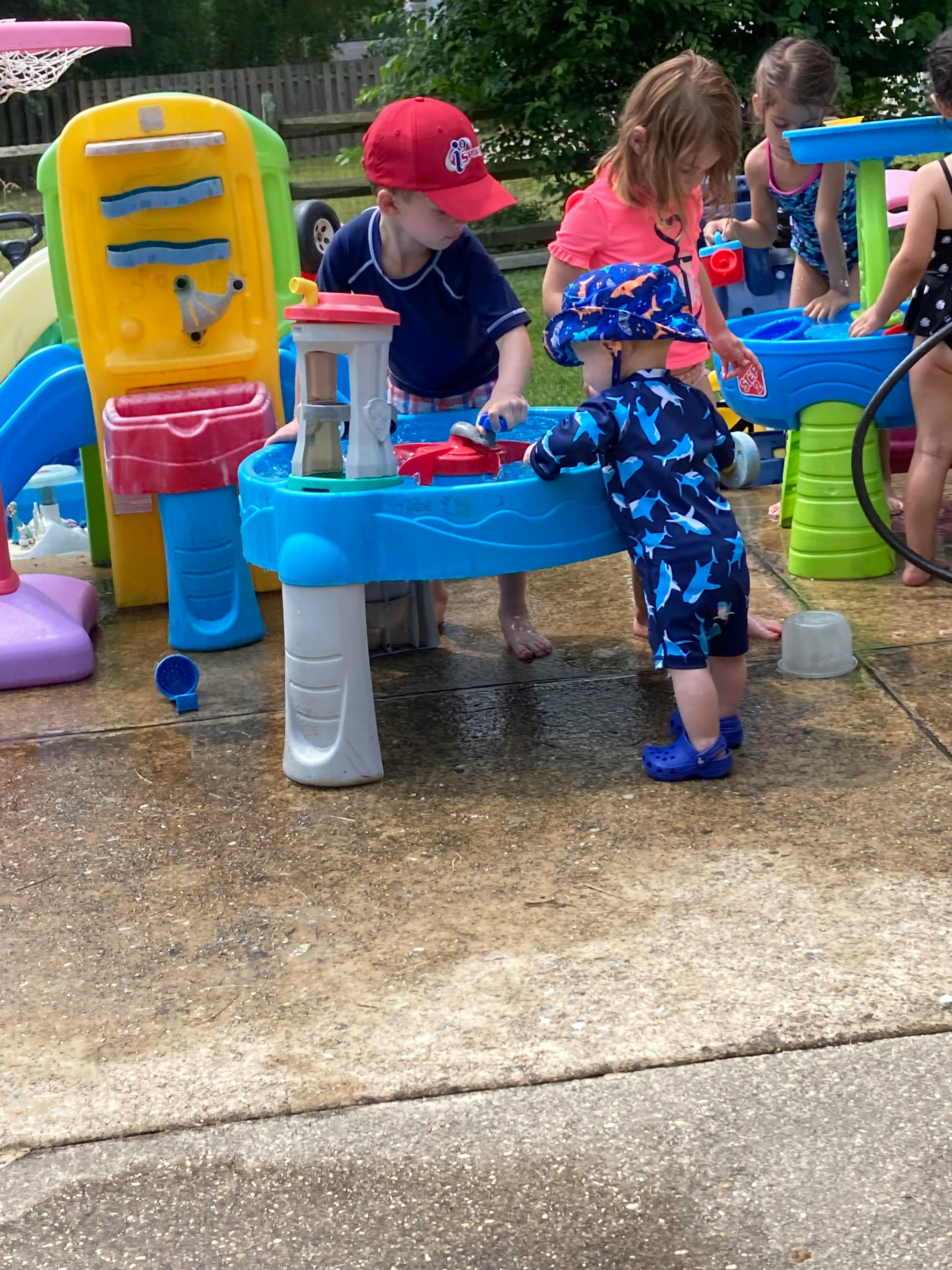 Children playing with a water table outdoors