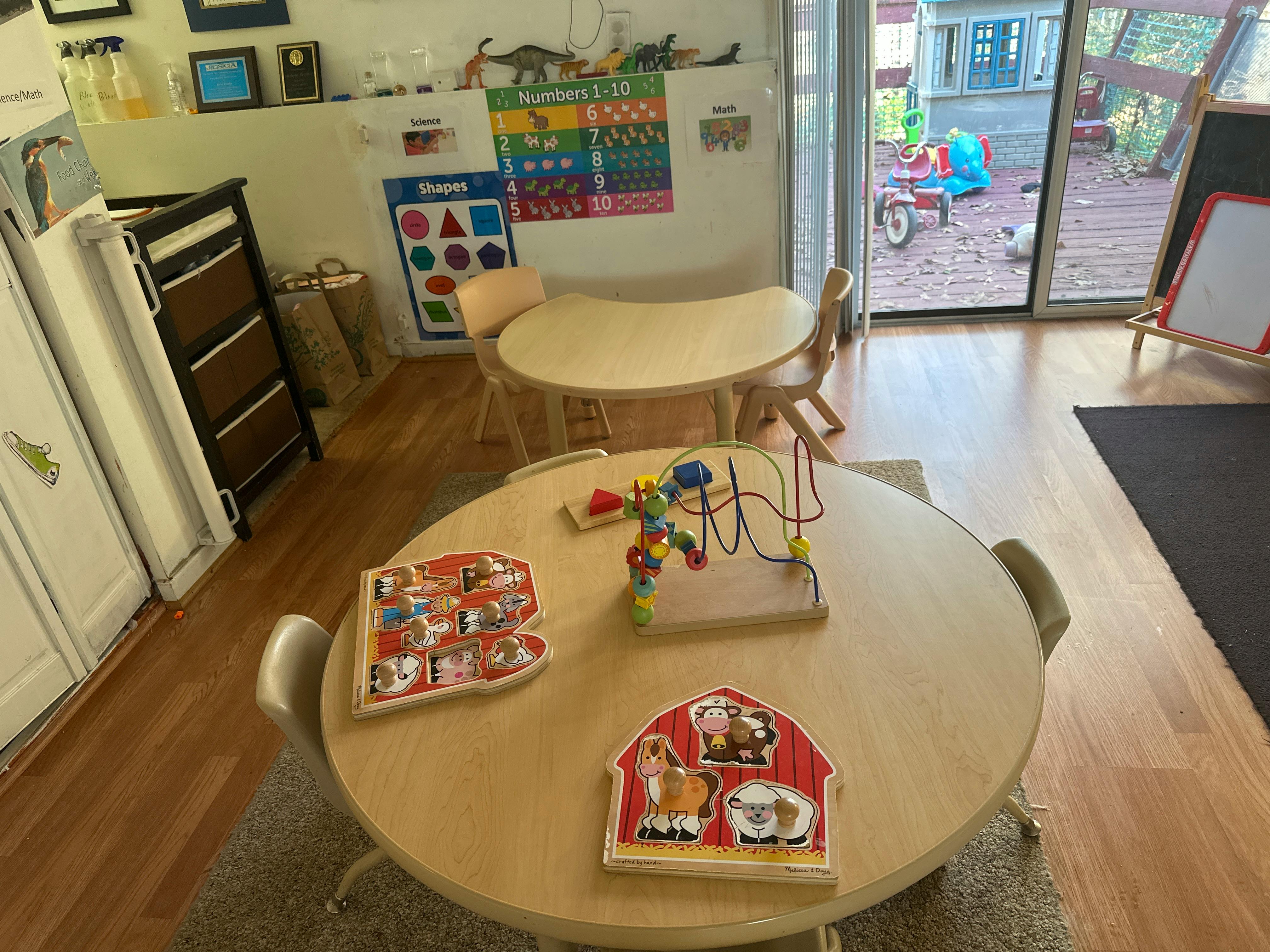 Classroom with small tables and chairs, toys on a table