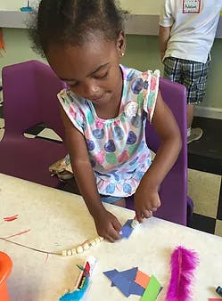 Child making crafts at a table