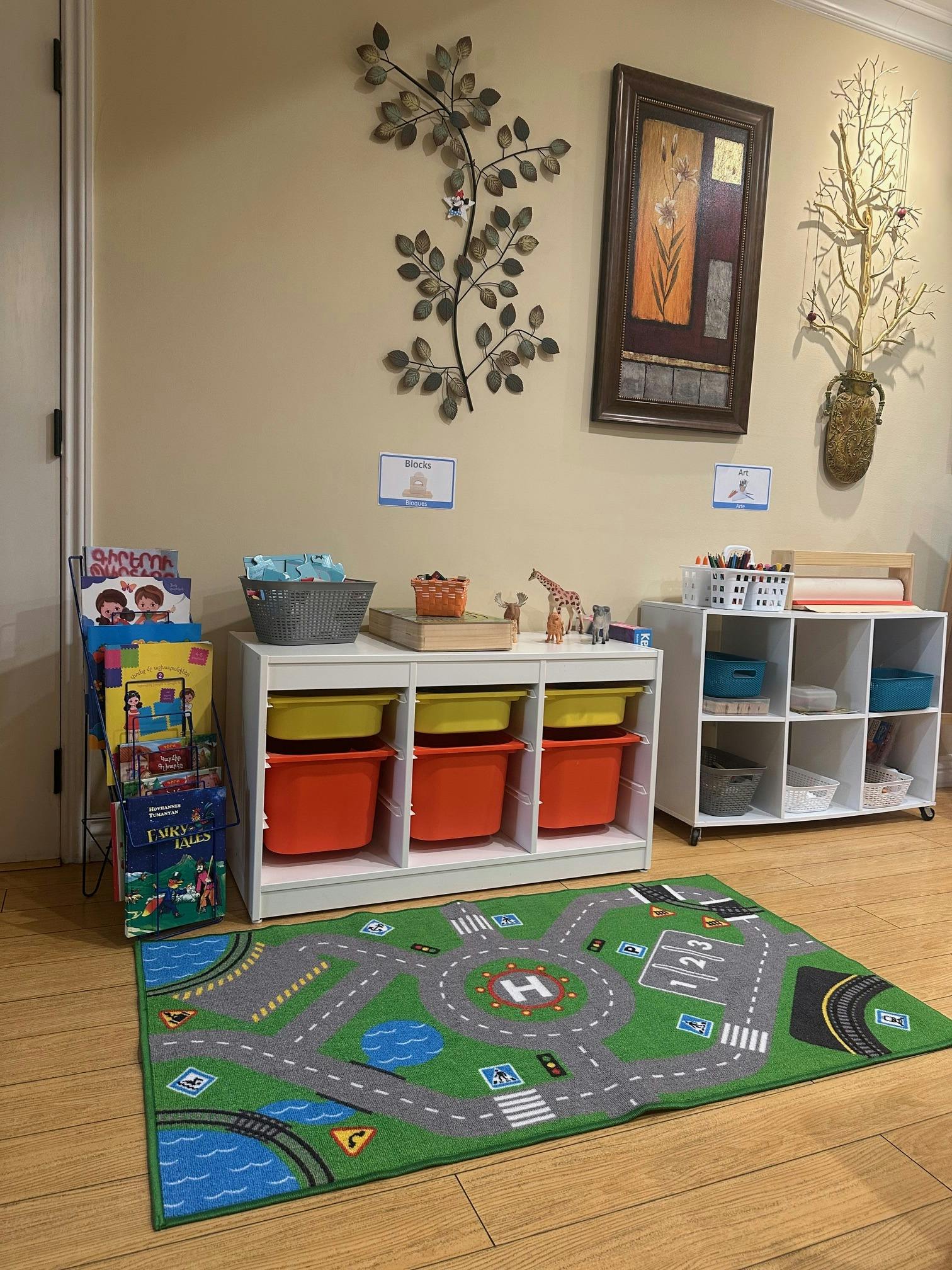 Playroom with toy storage, books, and a road map rug