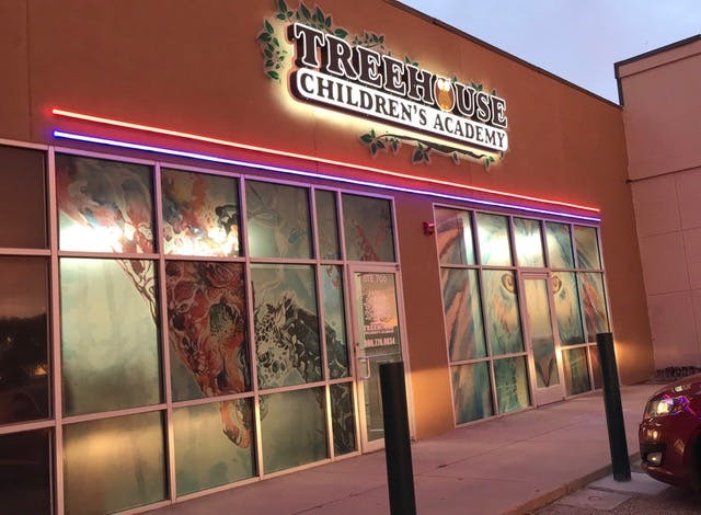Building exterior with a sign that reads "Treehouse Children's Academy"