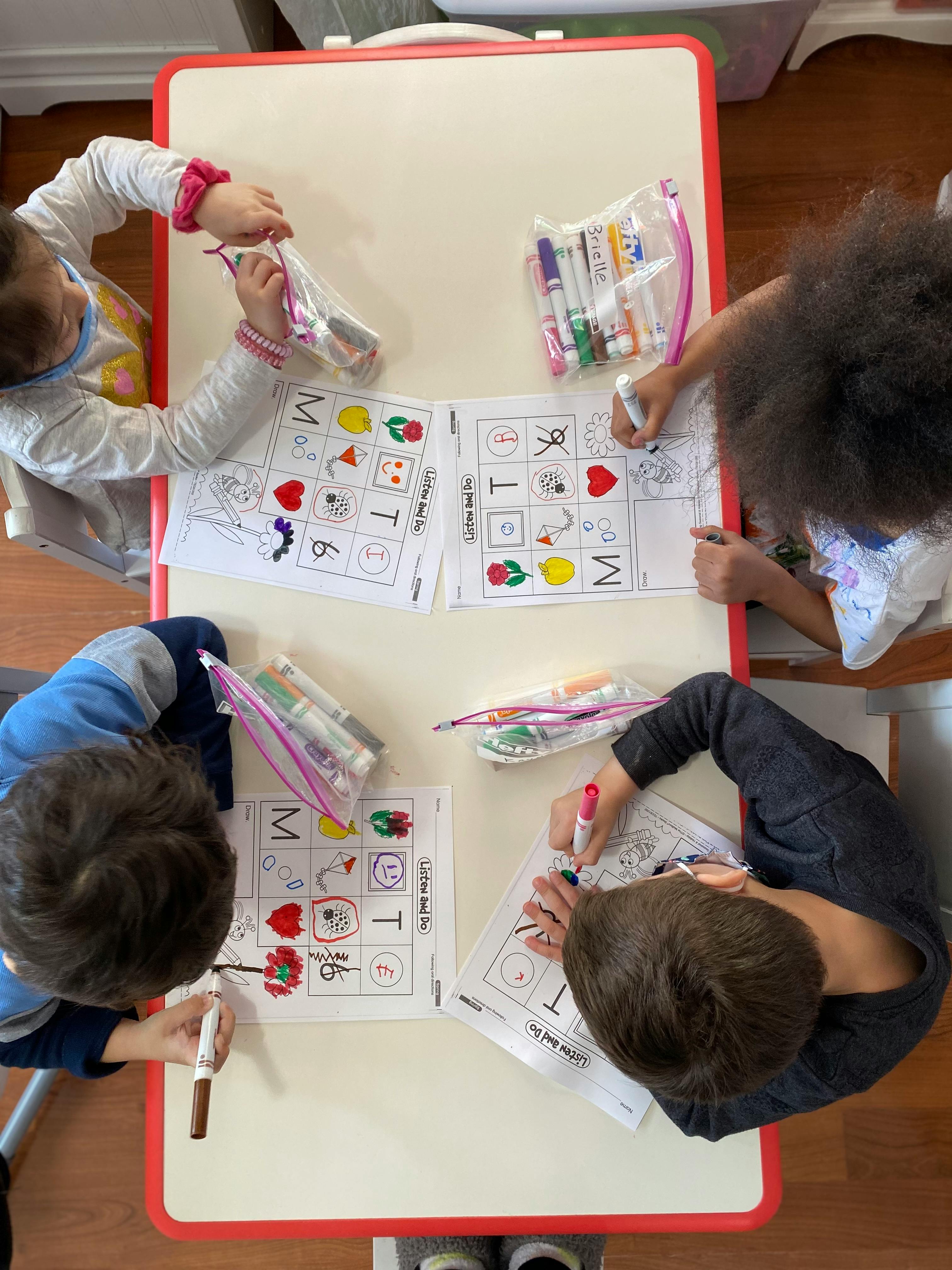 Children coloring at a table