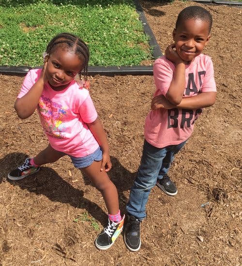Two children standing outdoors