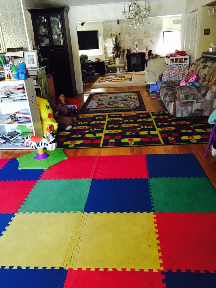 Playroom with colorful foam floor tiles and alphabet rug