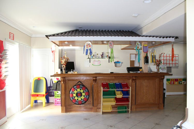 Reception desk with a colorful dartboard and storage bins