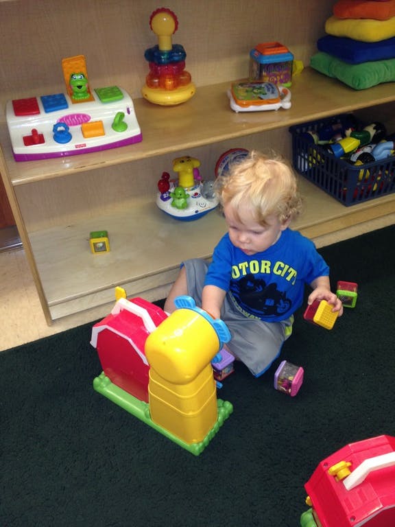 Child playing with toys on the floor