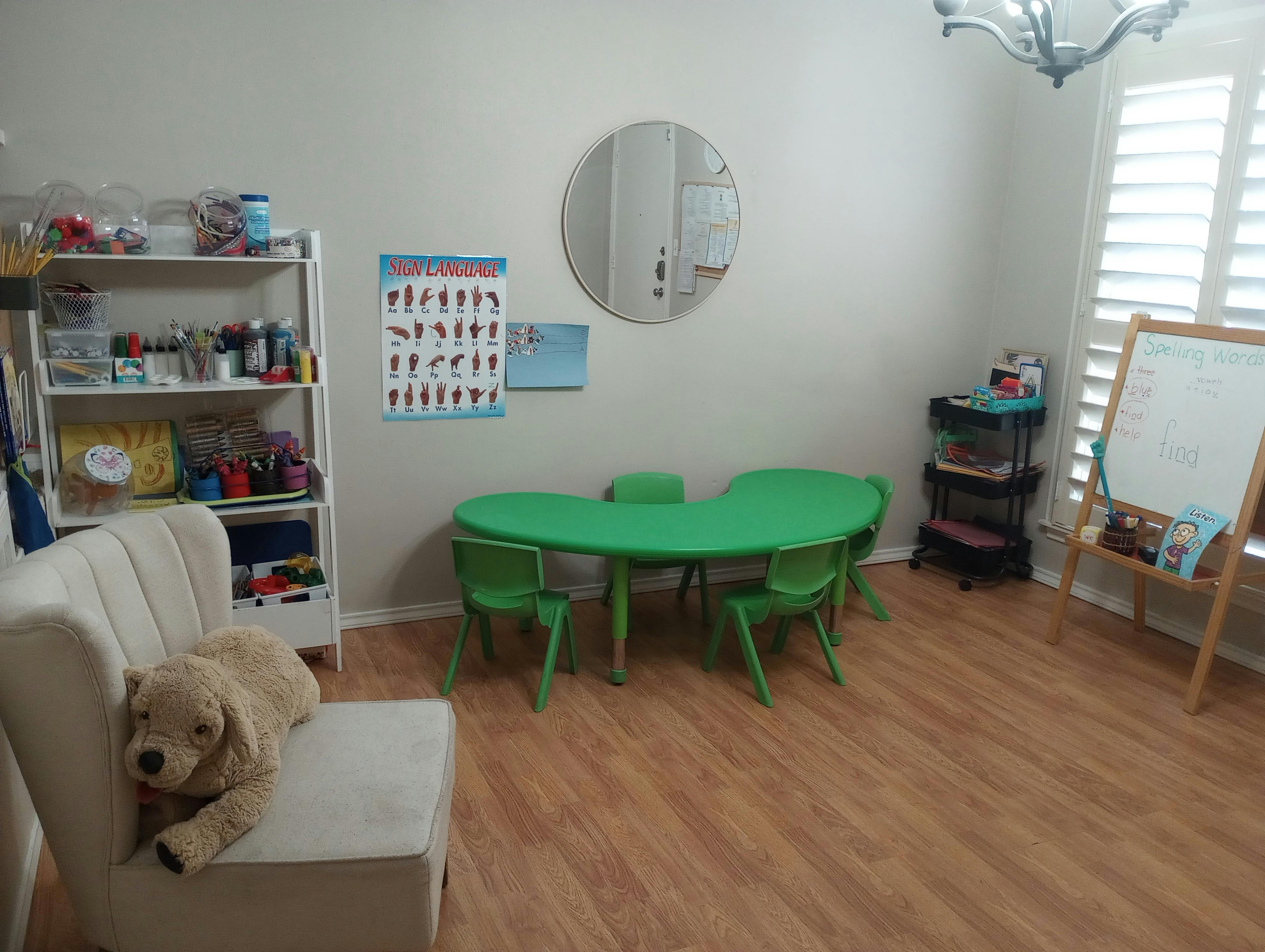 Stuffed dog on a chair in a room with a green table and chairs