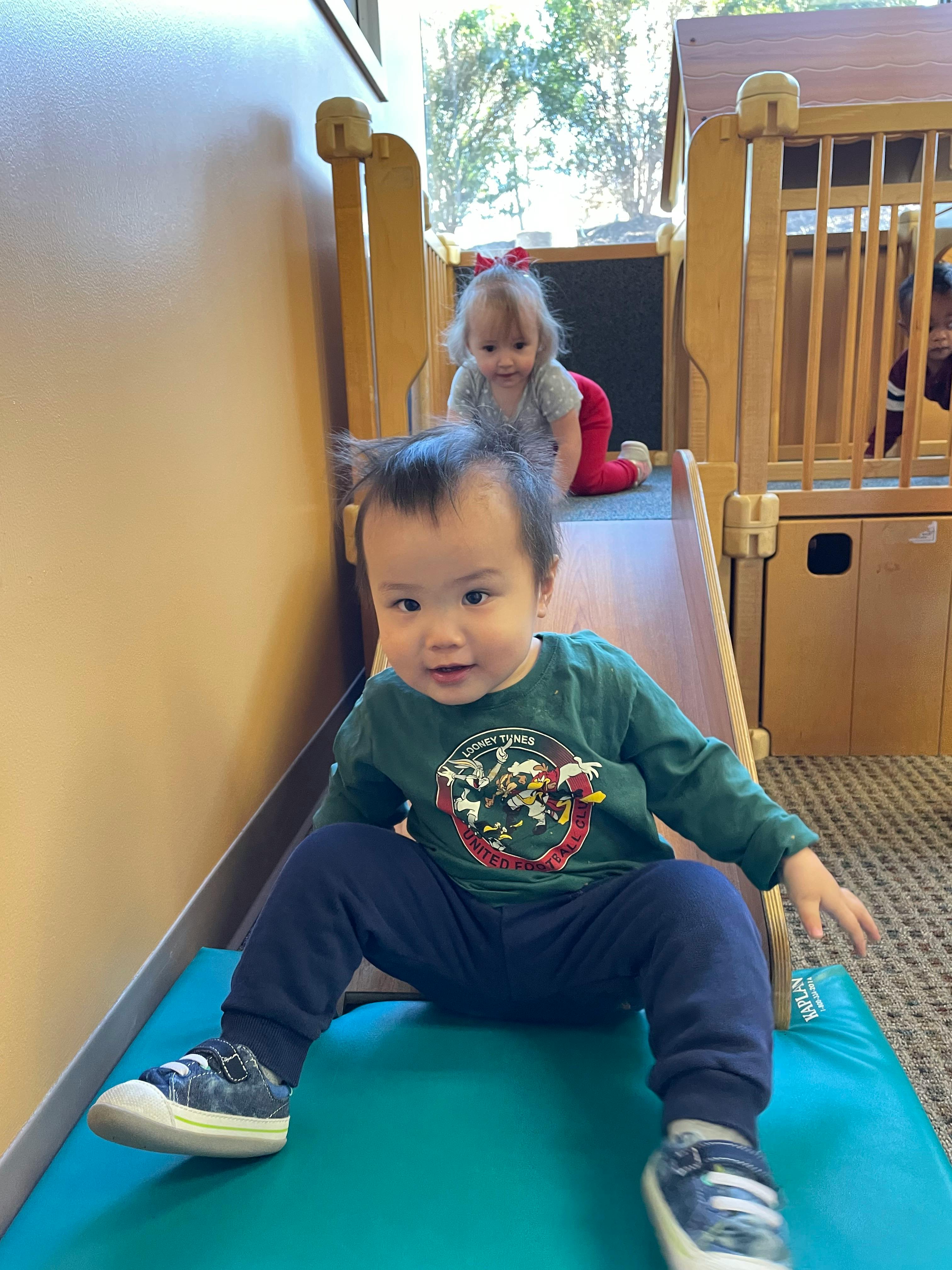 Two children on a play slide