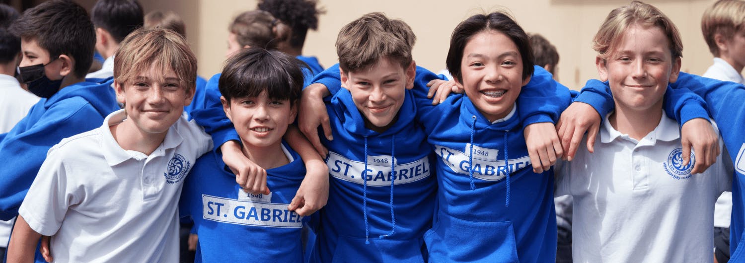 Five children in blue hoodies and white shirts with "ST. GABRIEL" text