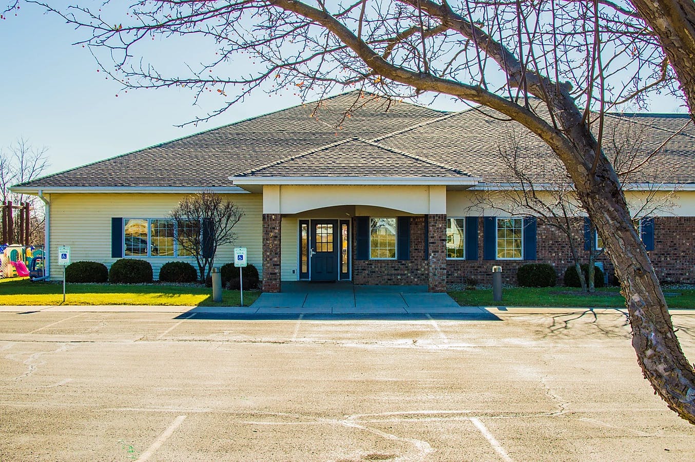Exterior of a building with a large parking lot in front