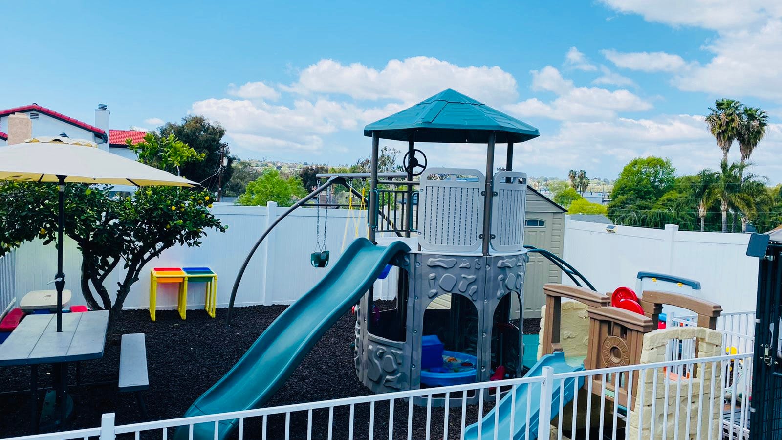 Outdoor playground with slides, swings, and a play structure