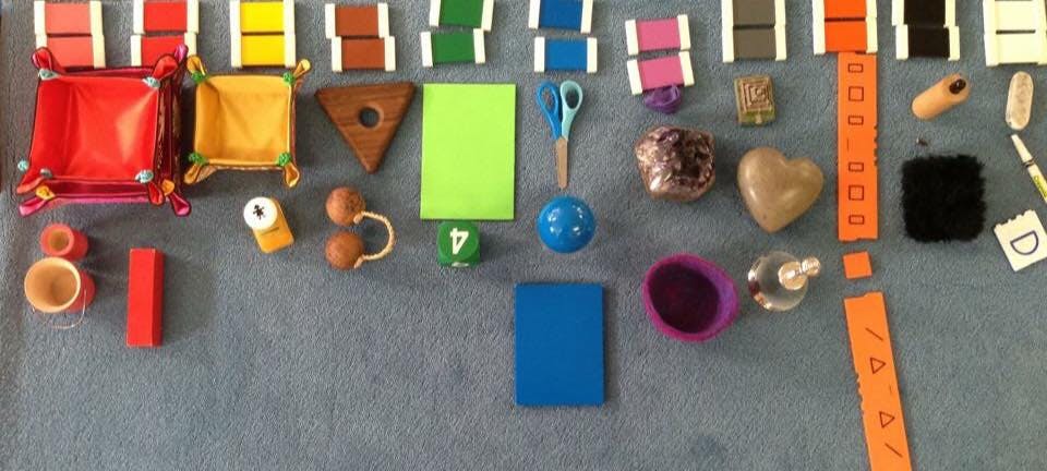 Assortment of colorful objects including blocks, trays, and craft supplies