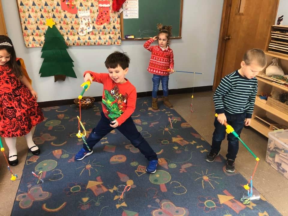 Children playing with toy fishing rods indoors