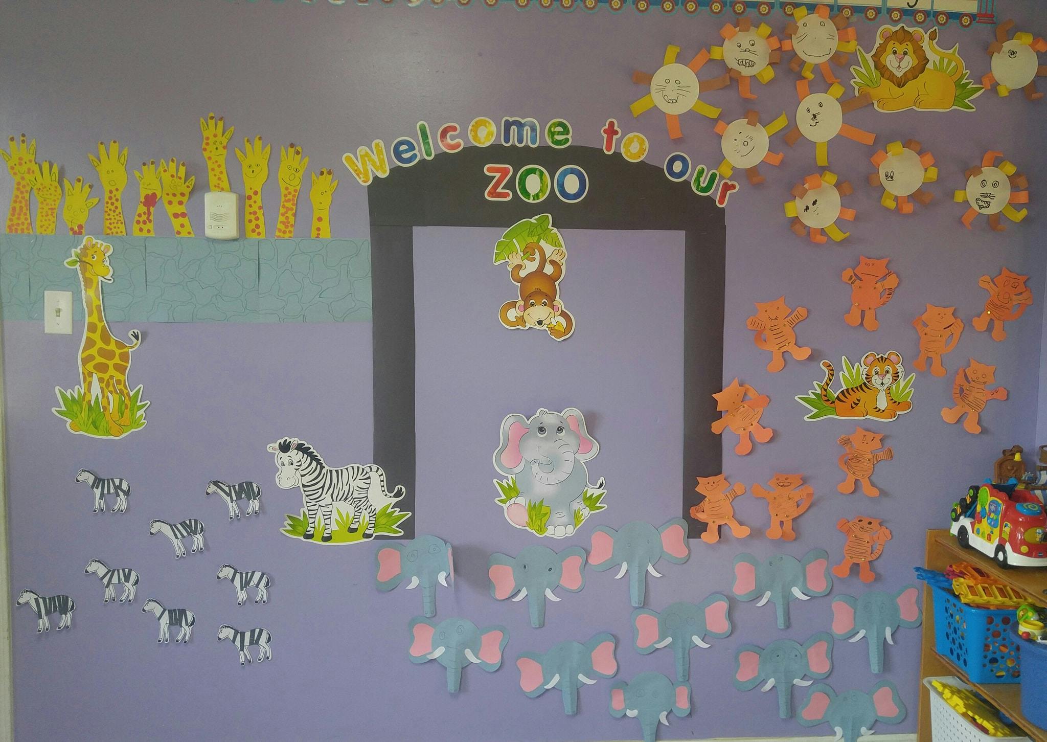 Classroom wall decorated with animal cutouts and "Welcome to our Zoo" sign