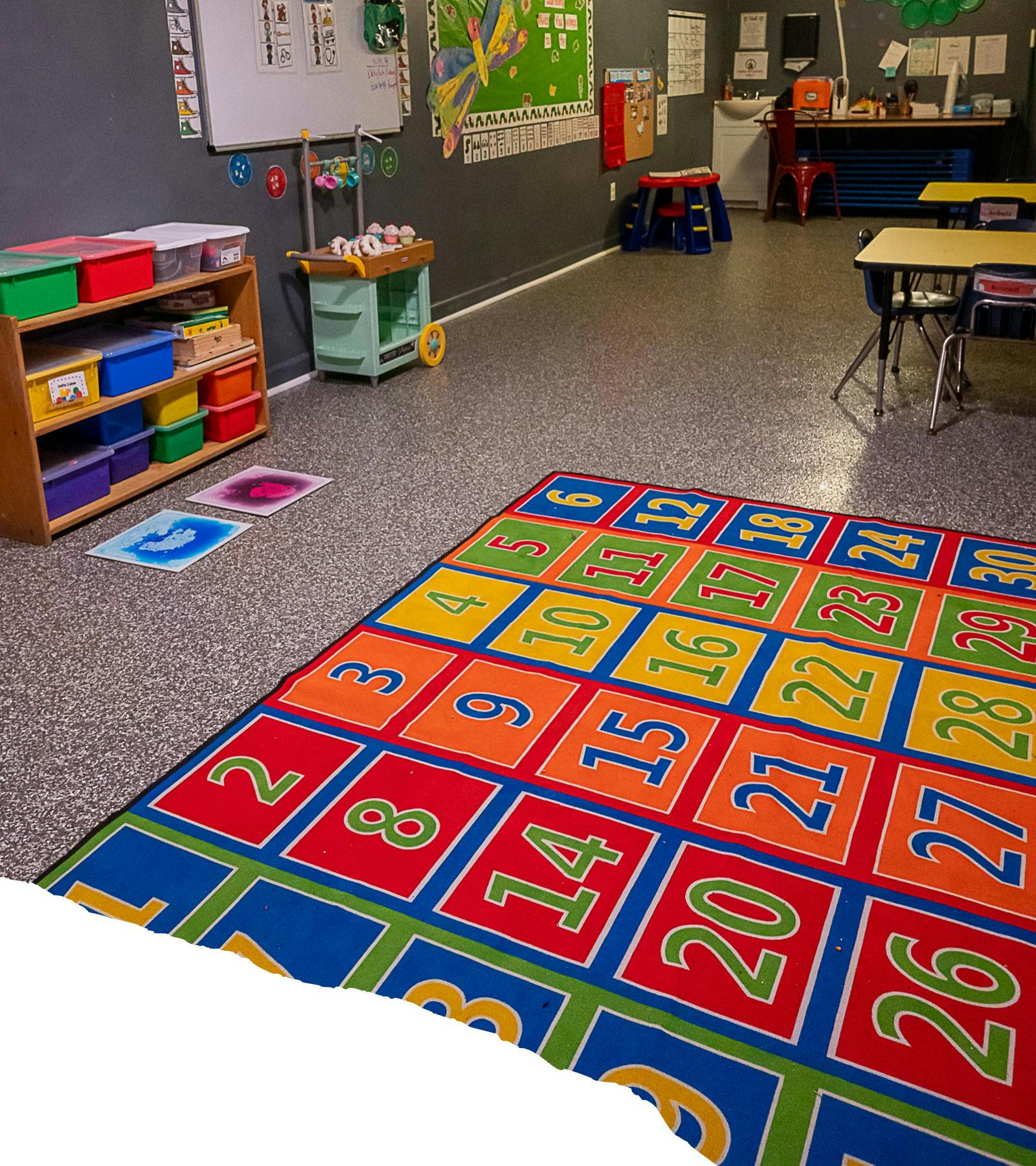 Classroom with a colorful number rug on the floor