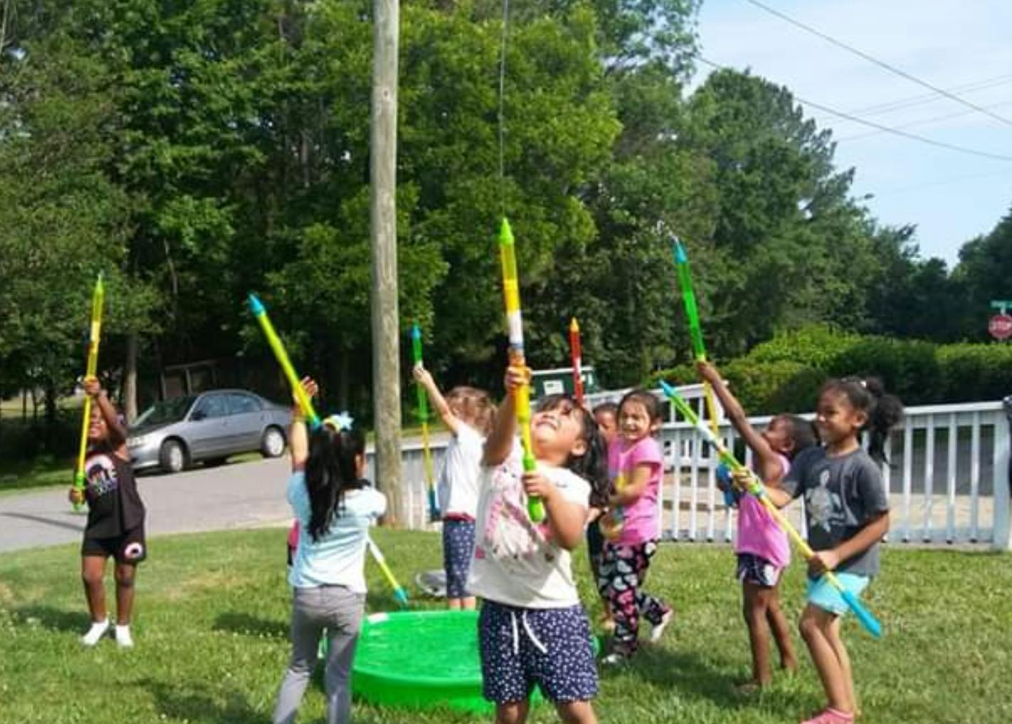 Children playing with water toys outdoors